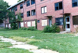 Picture of a low-income housing unit that functions as an open air drug market