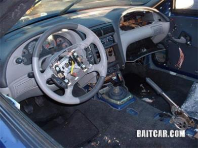 A Ford Mustang stripped of its airbags and other interior components.